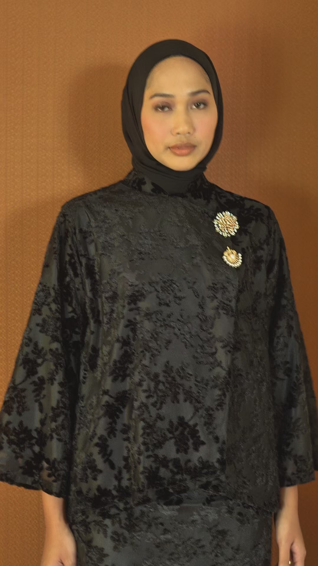 Woman wearing black floral velvet lace kebaya